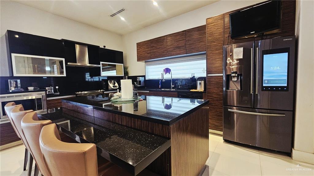 2213 South 48th Street McAllen, TX 78503 - Photo 8 of 28 a kitchen with stainless steel appliances granite countertop a sink a stove and refrigerator