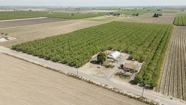 an aerial view of a house with outdoor space and lake view