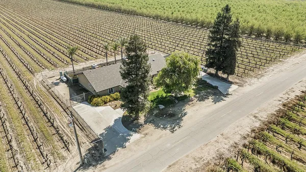 a view of a backyard with sitting area