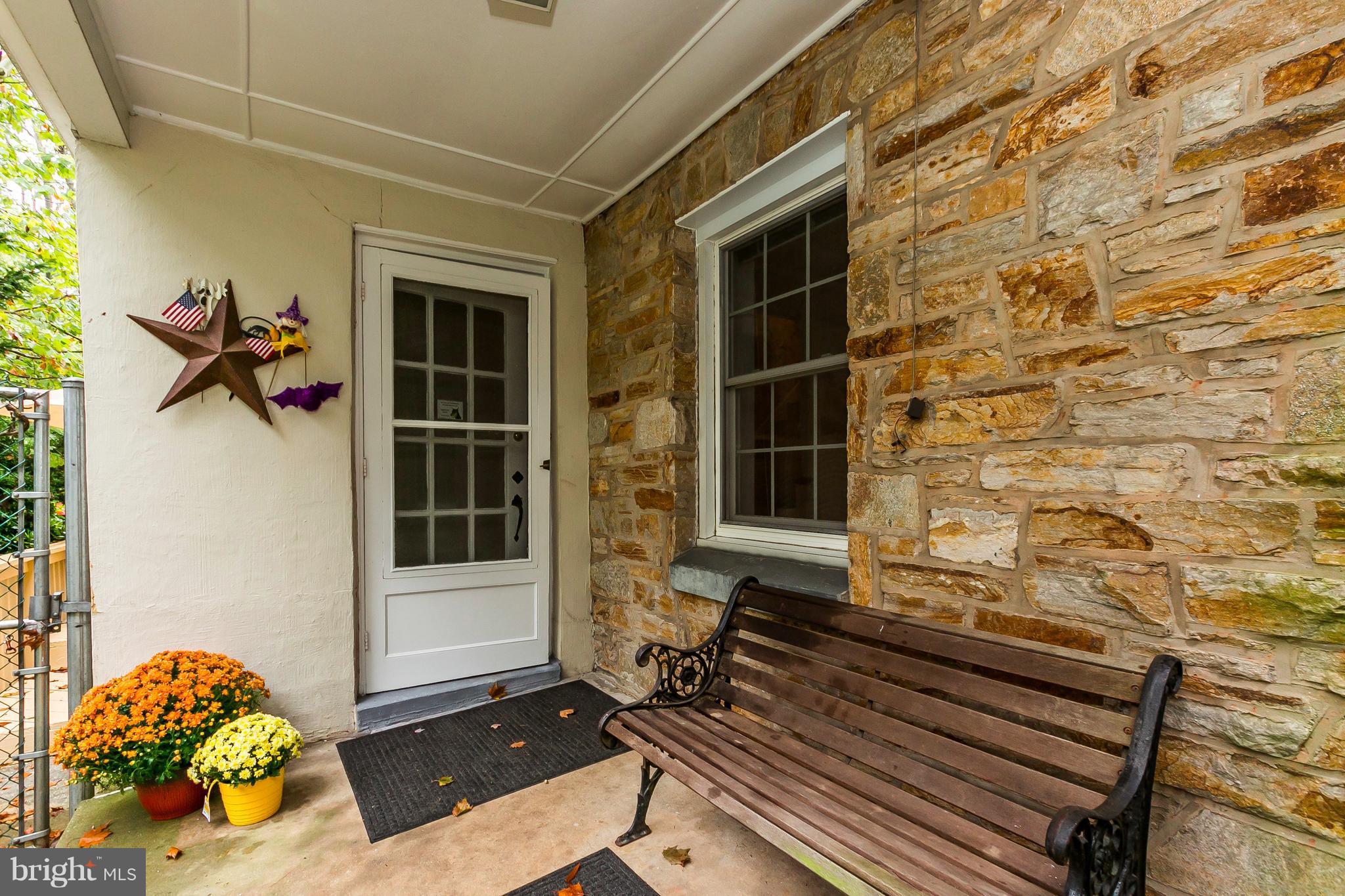 a front view of a house with outdoor seating