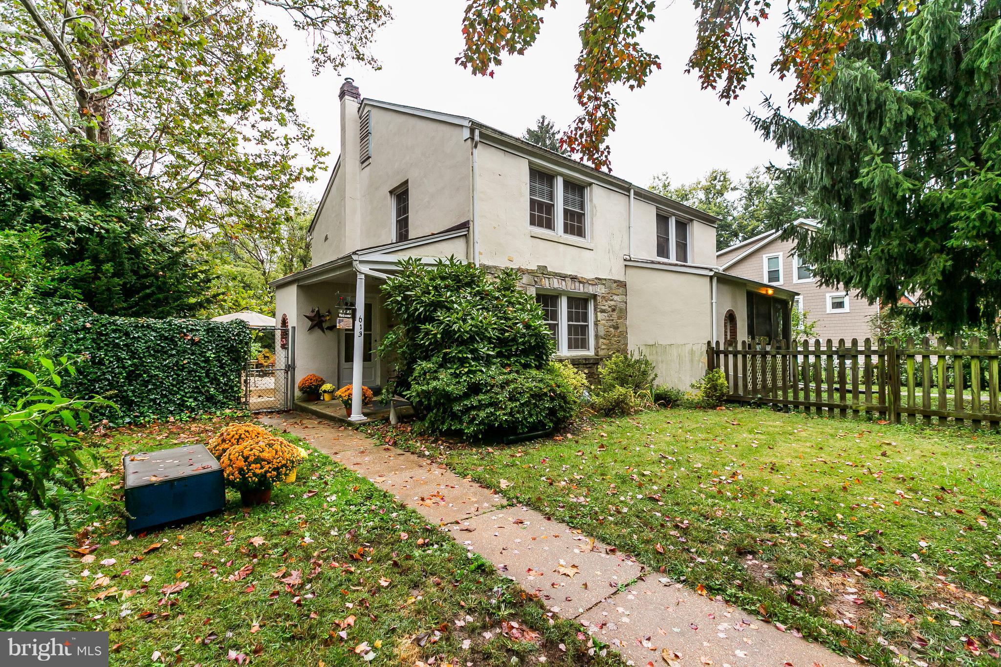 613 Deepdene Road Baltimore, MD 21210 - Photo 2 of 25 a backyard of a house with potted plants and large tree