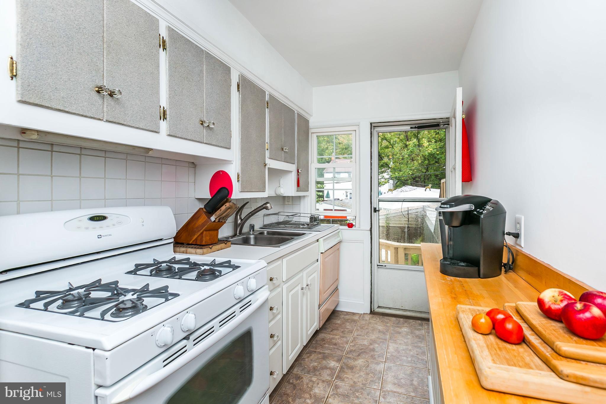 613 Deepdene Road Baltimore, MD 21210 - Photo 11 of 25 a kitchen with stainless steel appliances kitchen island granite countertop a stove and a sink
