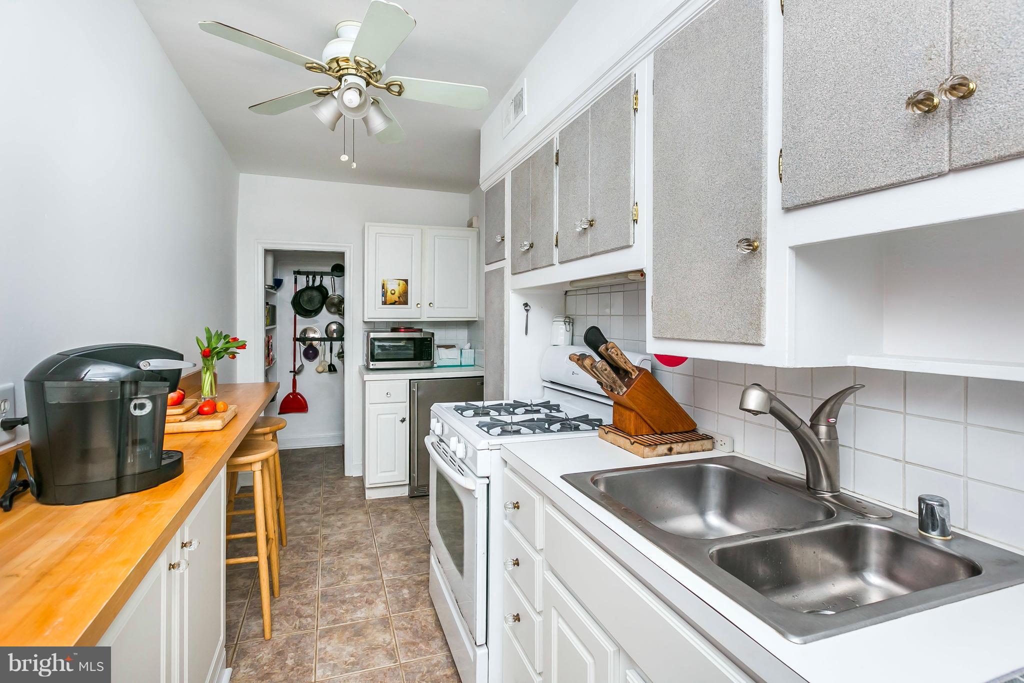 613 Deepdene Road Baltimore, MD 21210 - Photo 12 of 25 a kitchen that has a lot of cabinets a sink and appliances