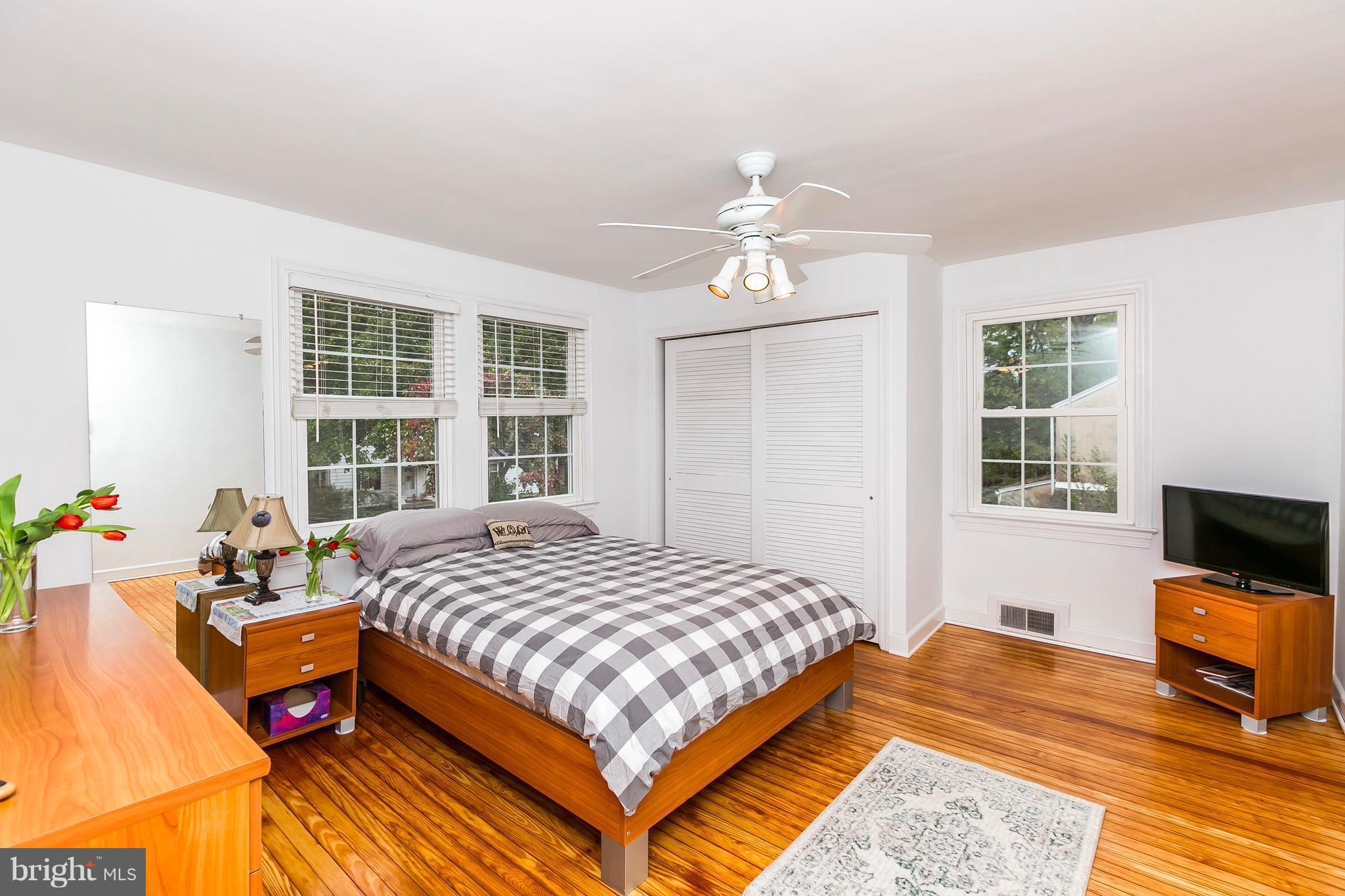 613 Deepdene Road Baltimore, MD 21210 - Photo 14 of 25 a bedroom with a bed and wooden floor