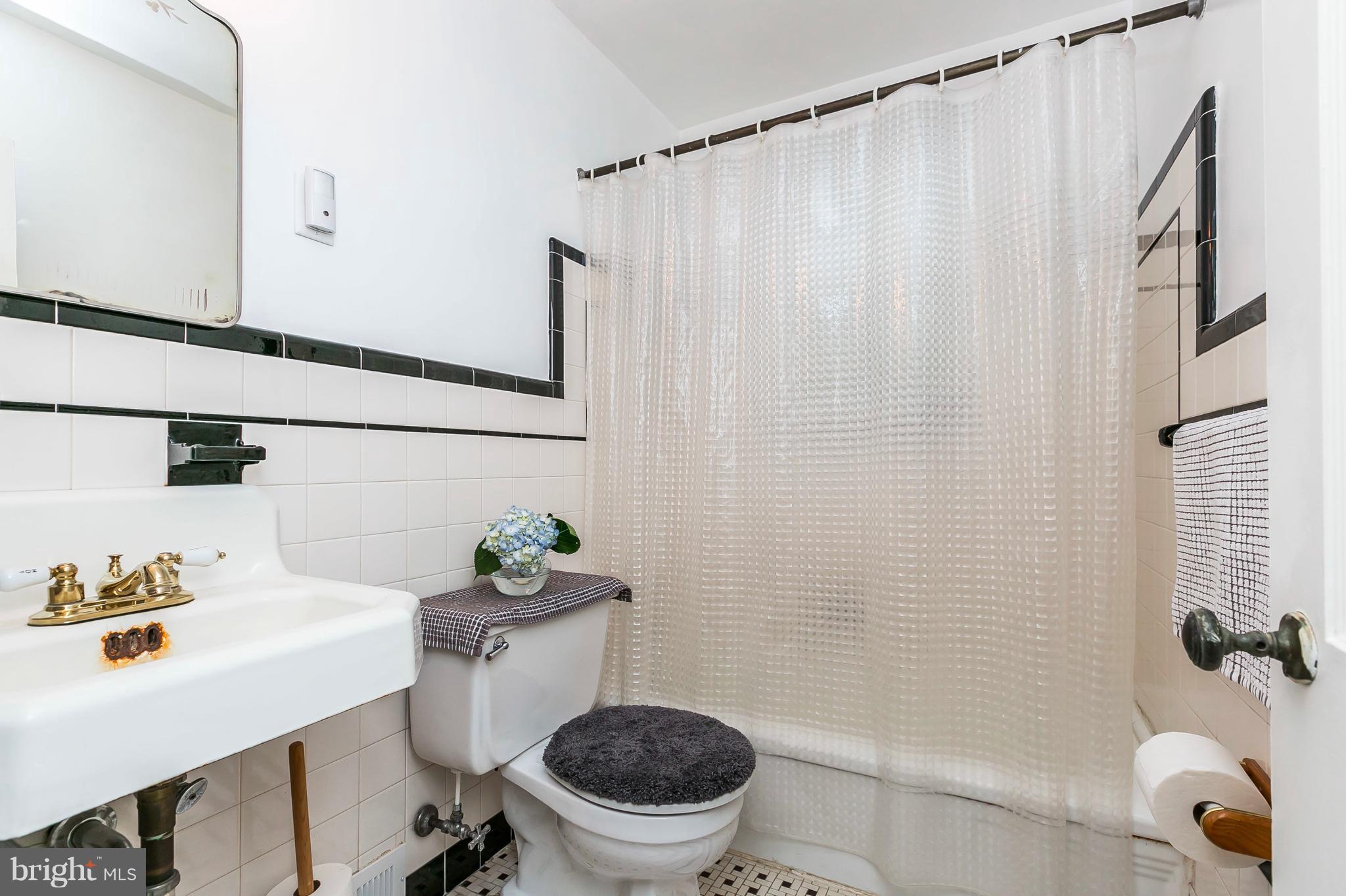 613 Deepdene Road Baltimore, MD 21210 - Photo 15 of 25 a bathroom with a sink a toilet and a mirror
