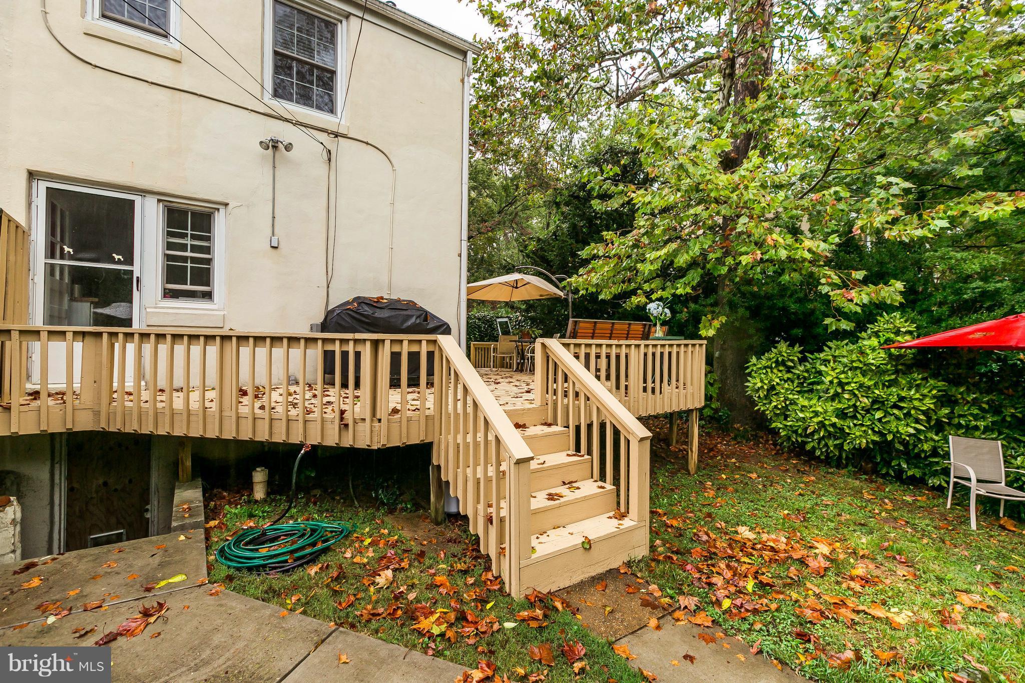613 Deepdene Road Baltimore, MD 21210 - Photo 18 of 25 a view of a house with large windows and a small yard with wooden fence