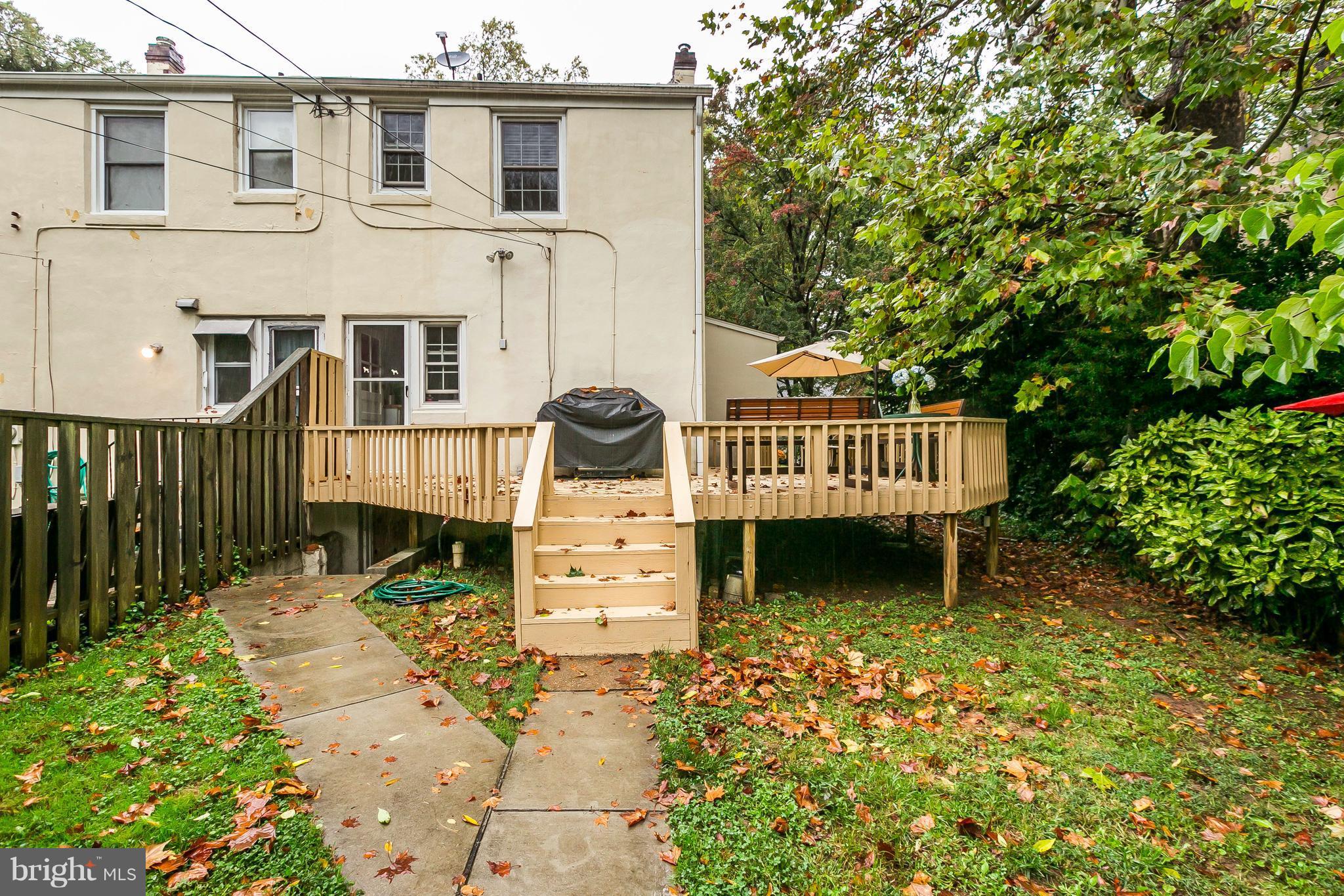 613 Deepdene Road Baltimore, MD 21210 - Photo 20 of 25 a view of a brick house with wooden fence next to a yard