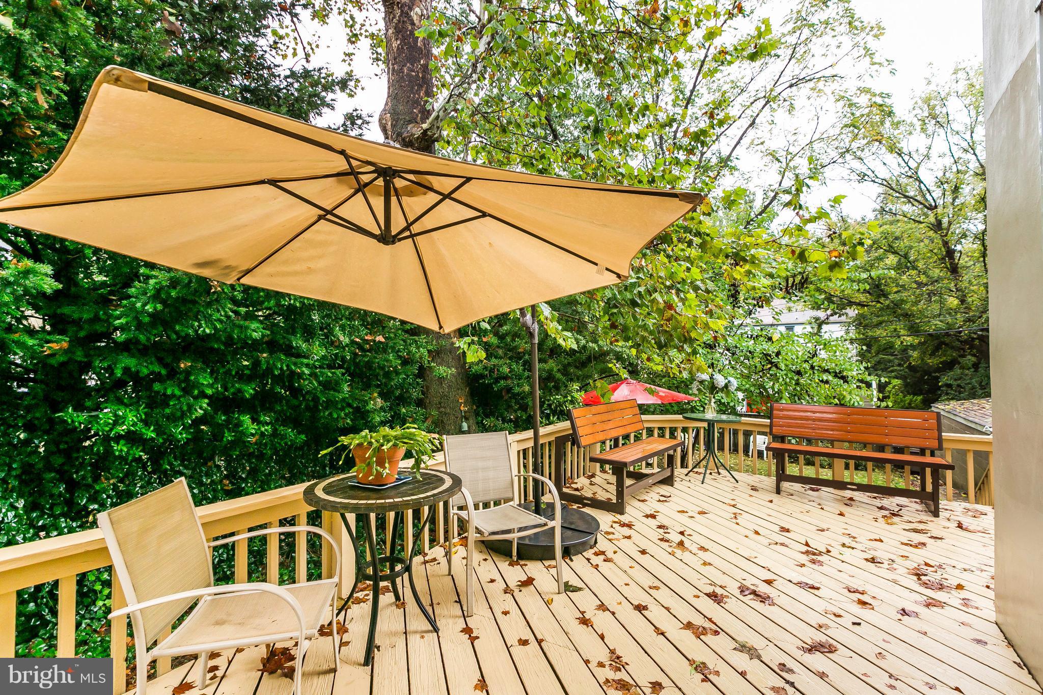 613 Deepdene Road Baltimore, MD 21210 - Photo 9 of 25 a backyard of a house with table and chairs under an umbrella