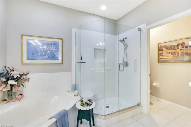 a bathroom with a tub shower and a sink