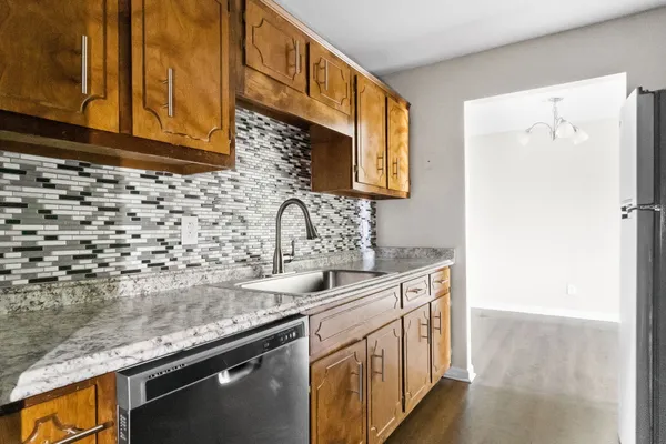 a kitchen with a sink a stove and a refrigerator