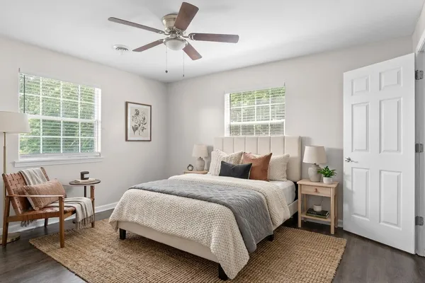 a bedroom with a bed a table and chair