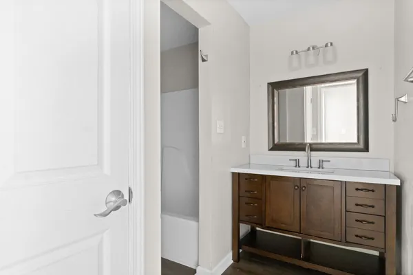 a bathroom with a sink a mirror and shower