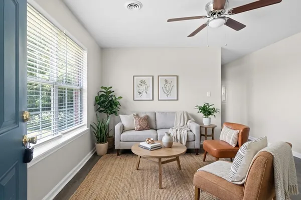 a living room with furniture and a large window