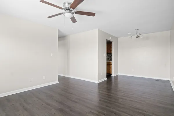 a view of an empty room with wooden floor