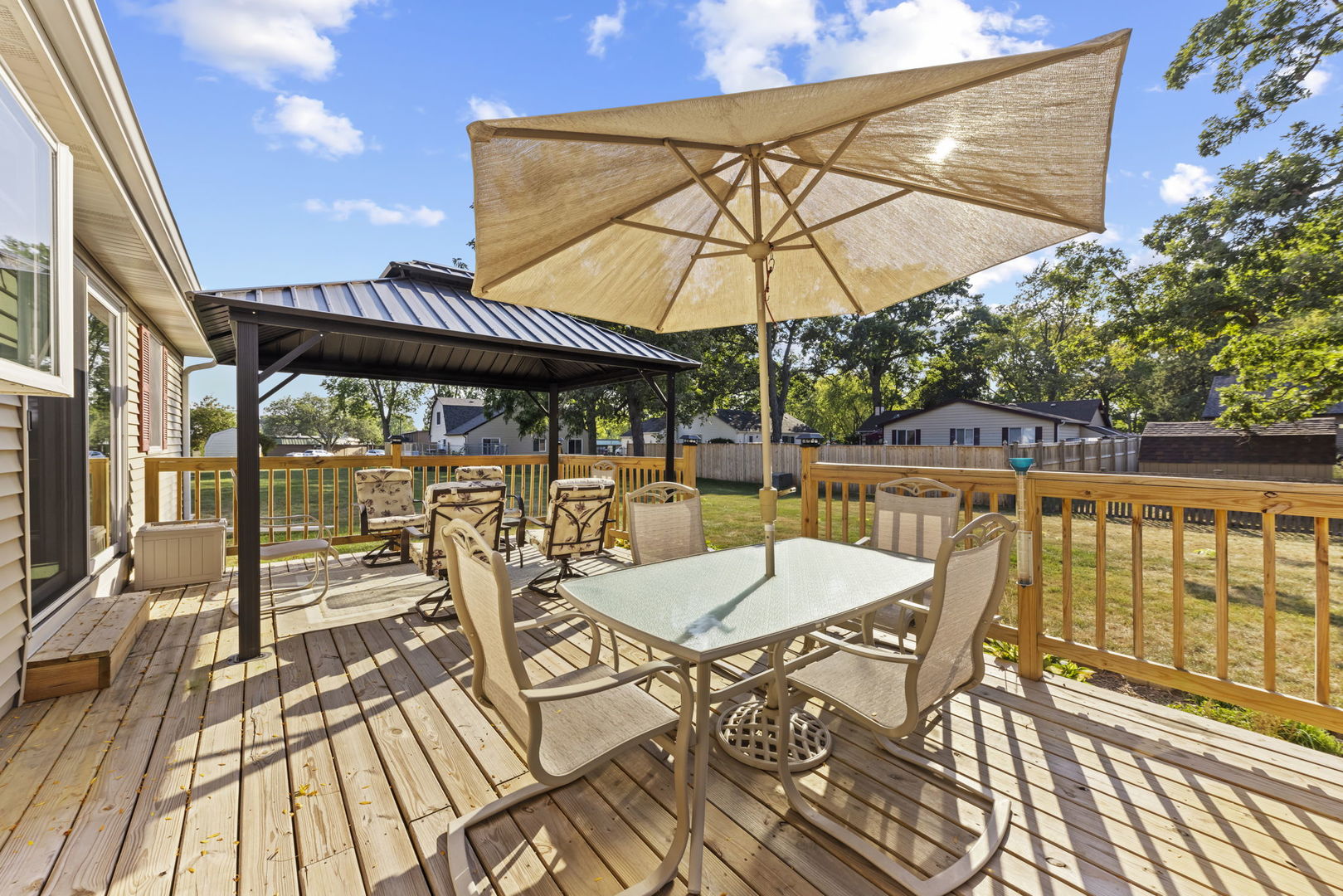 52 Winrock Road Montgomery, IL 60538 - Photo 23 of 28 a view of a patio with a table and chairs under an umbrella