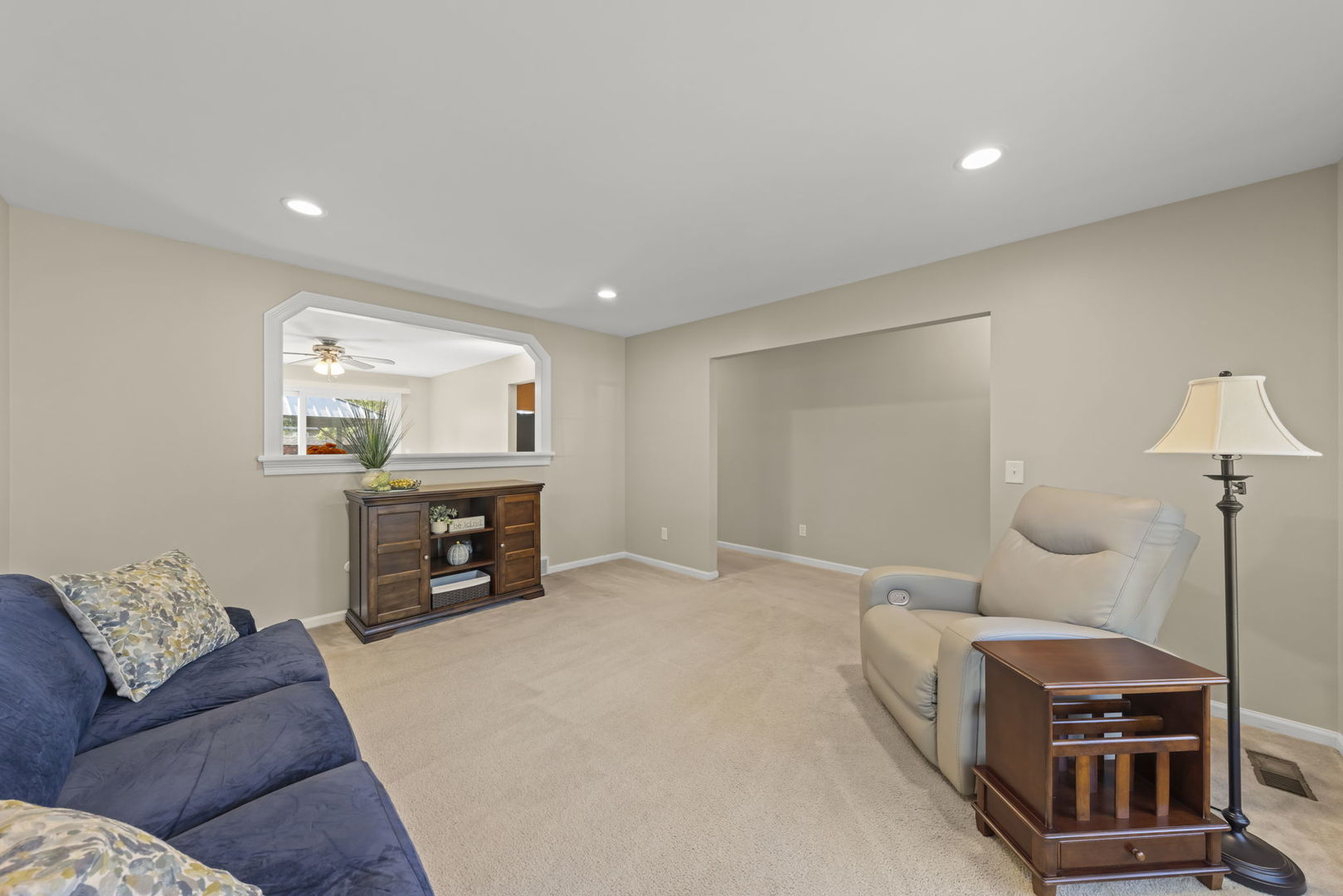 52 Winrock Road Montgomery, IL 60538 - Photo 4 of 28 a living room with a couch and a chandelier