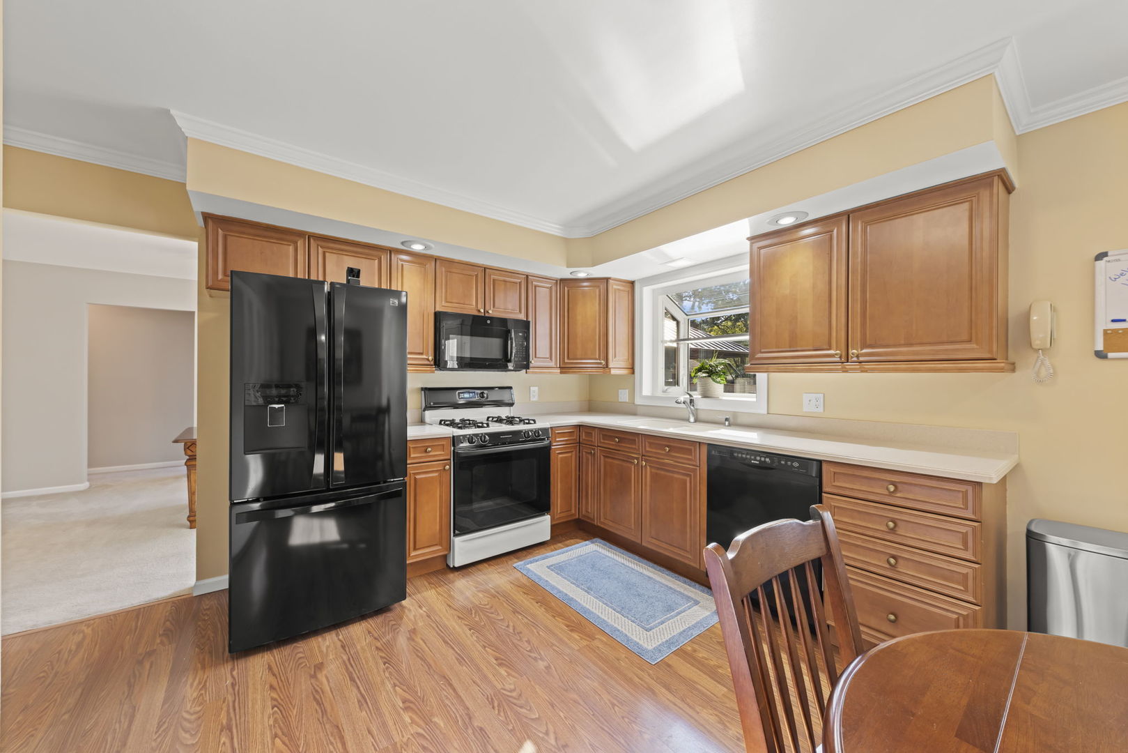52 Winrock Road Montgomery, IL 60538 - Photo 7 of 28 a kitchen with stainless steel appliances granite countertop a refrigerator a stove top oven and sink