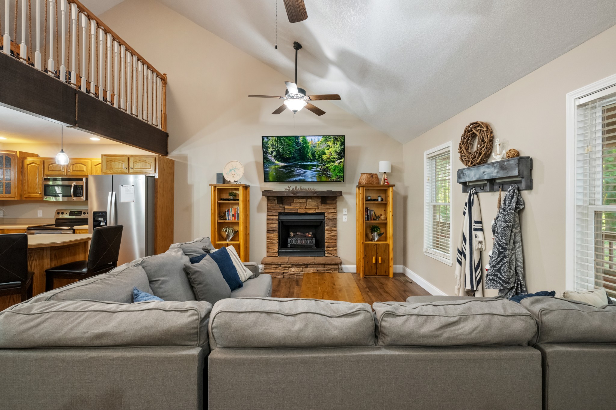 165 Kangaroo Ridge Road Byrdstown, TN 38549 - Photo 6 of 27 a living room with furniture a fireplace a chandelier and a flat screen tv