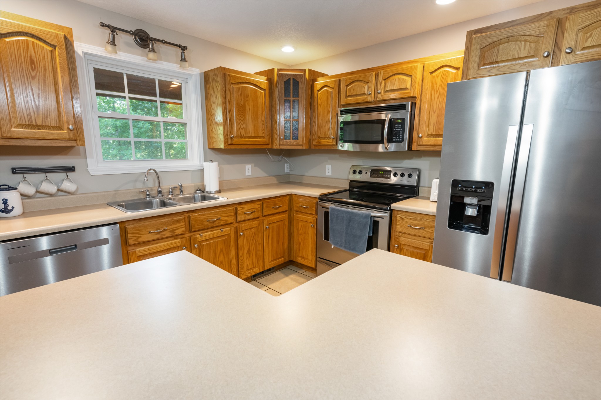 165 Kangaroo Ridge Road Byrdstown, TN 38549 - Photo 9 of 27 a kitchen with stainless steel appliances granite countertop a sink stove and refrigerator