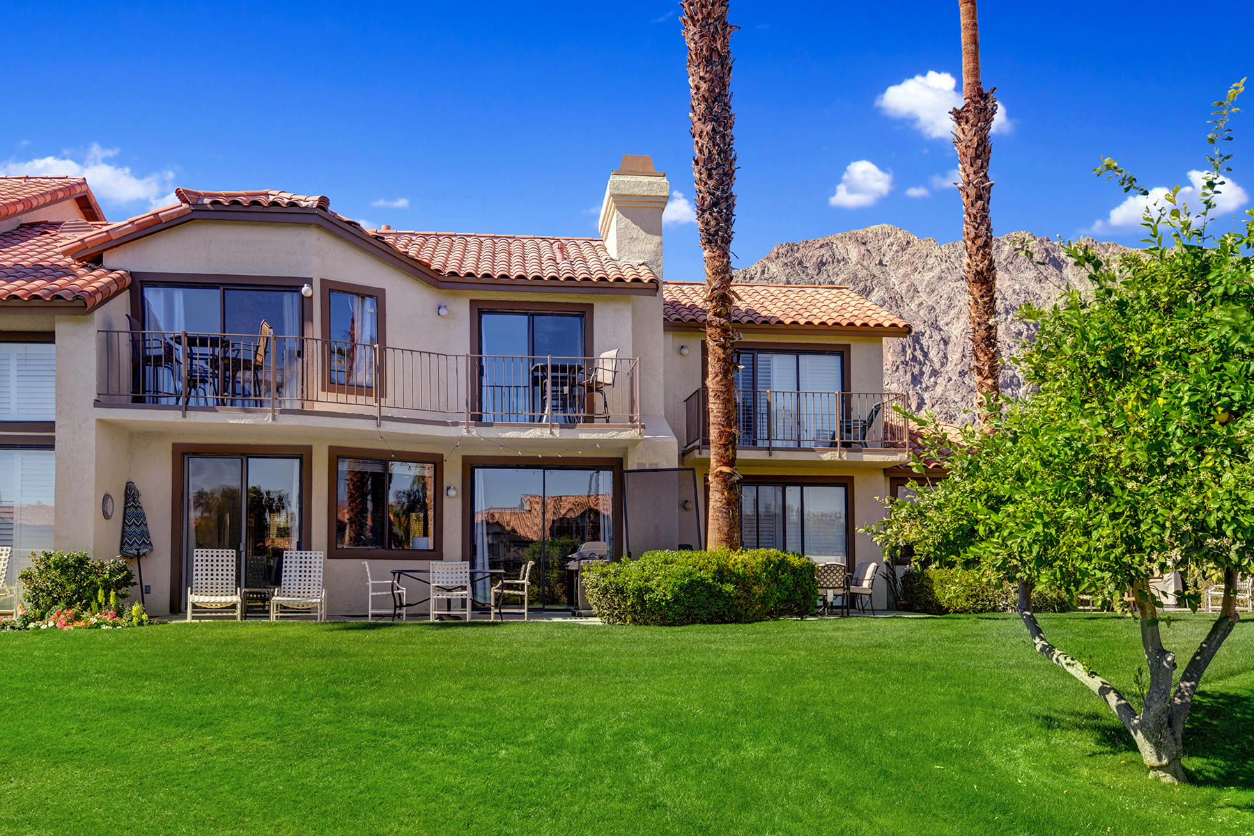 55108 Firestone La Quinta, CA 92253 - Photo 20 of 26 a front view of a house with a garden