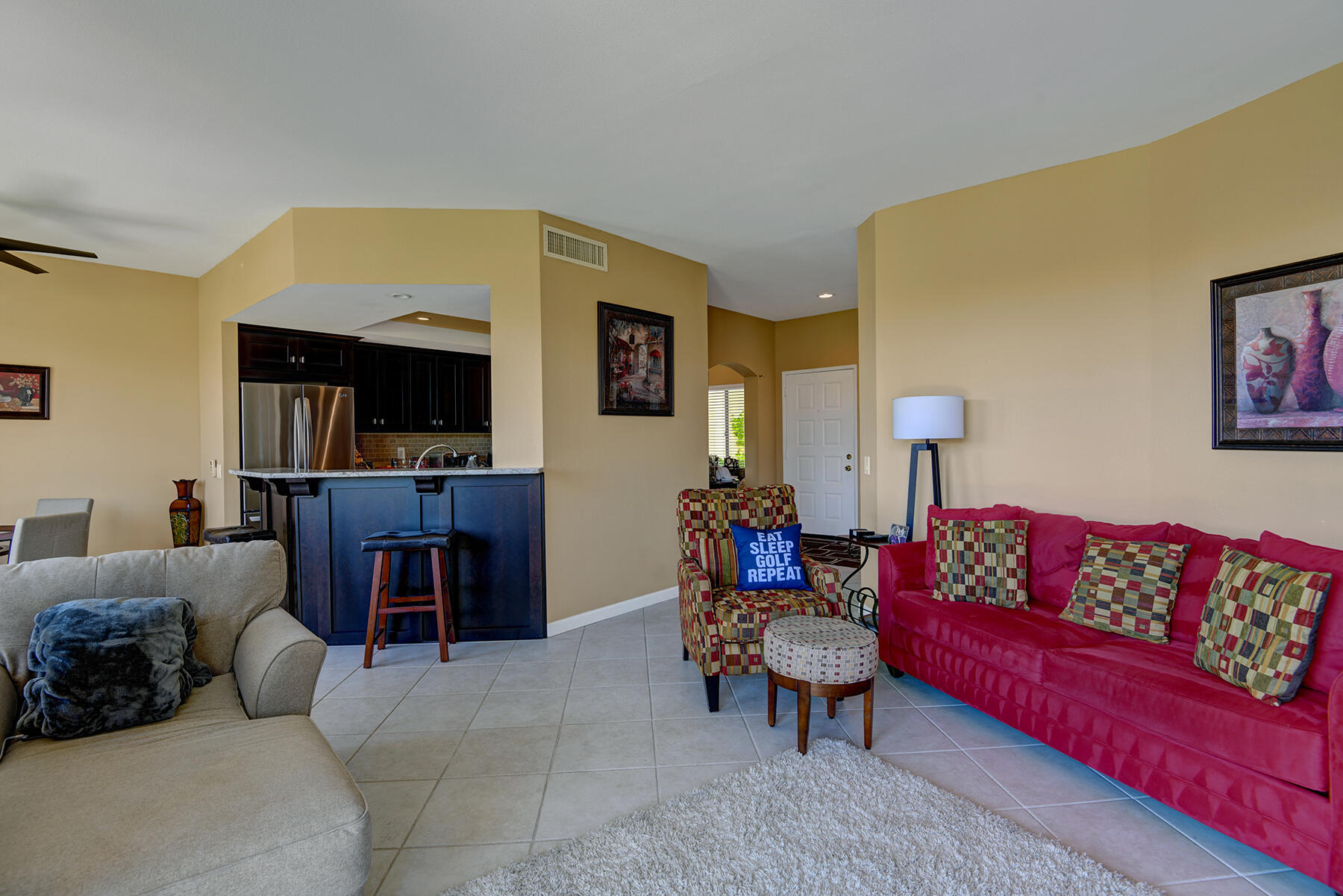 55108 Firestone La Quinta, CA 92253 - Photo 3 of 26 a living room with fireplace furniture and a flat screen tv
