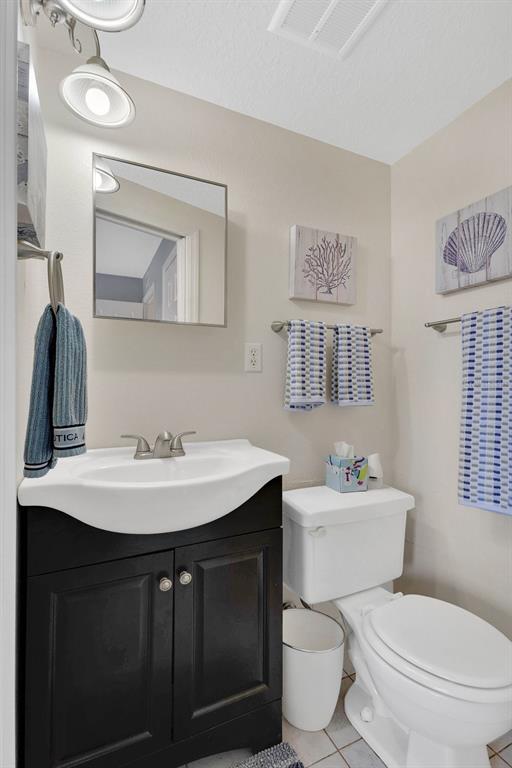 1024 North Plantation Drive, Unit B9 Kissimmee, FL 34741 - Photo 12 of 28 a bathroom with a toilet a sink and mirror