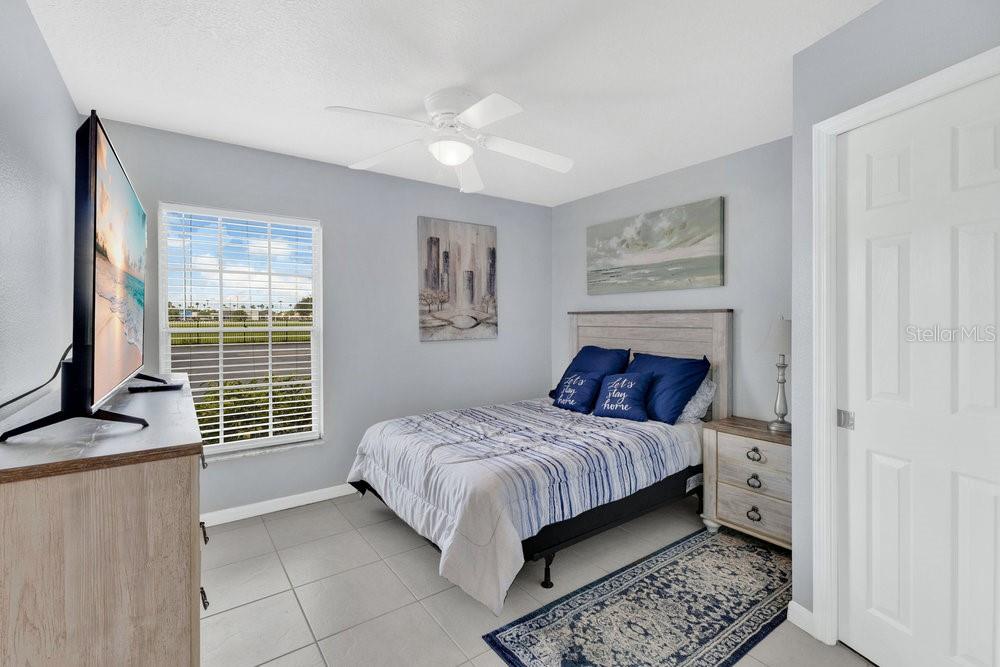 1024 North Plantation Drive, Unit B9 Kissimmee, FL 34741 - Photo 13 of 28 a bedroom with a bed and a window