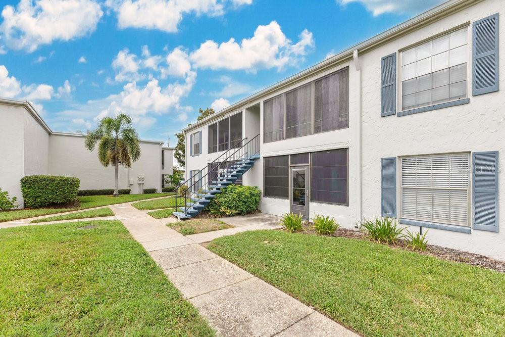 1024 North Plantation Drive, Unit B9 Kissimmee, FL 34741 - Photo 15 of 28 a front view of a house with garden