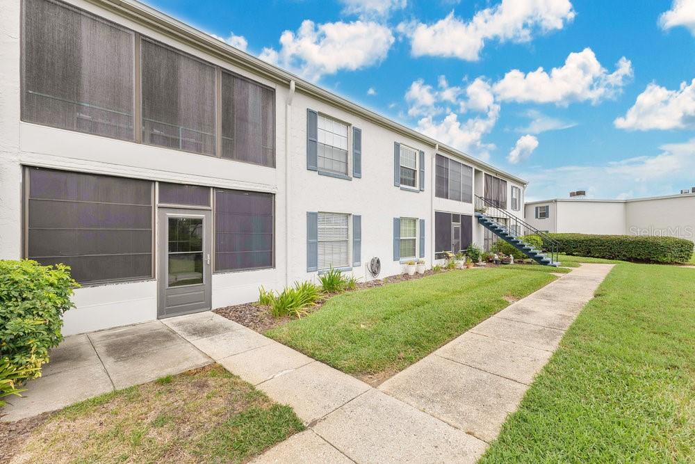 1024 North Plantation Drive, Unit B9 Kissimmee, FL 34741 - Photo 16 of 28 a view of a house with a yard