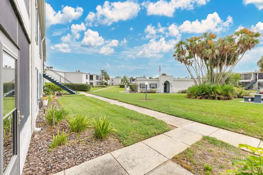 1024 North Plantation Drive, Unit B9 Kissimmee, FL 34741 - Photo 17 of 28 a view of a garden with a building in the background
