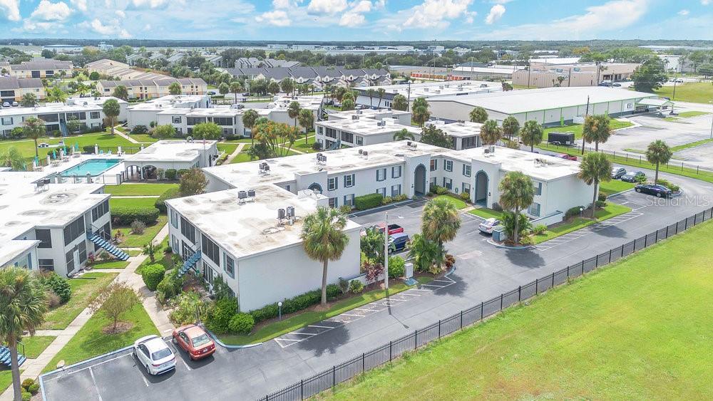 1024 North Plantation Drive, Unit B9 Kissimmee, FL 34741 - Photo 22 of 28 an aerial view of a house with a garden and lake view