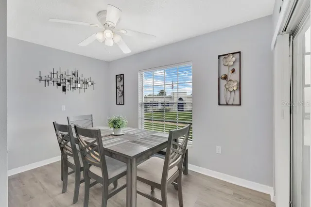 a view of a dining room with furniture and chandelier