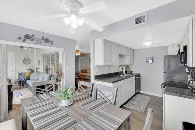 a kitchen with a sink appliances and a dining table