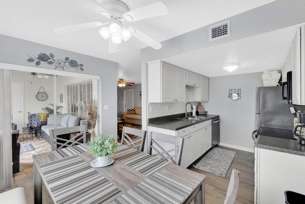 1024 North Plantation Drive, Unit B9 Kissimmee, FL 34741 - Photo 6 of 28 a kitchen with a sink appliances and a dining table