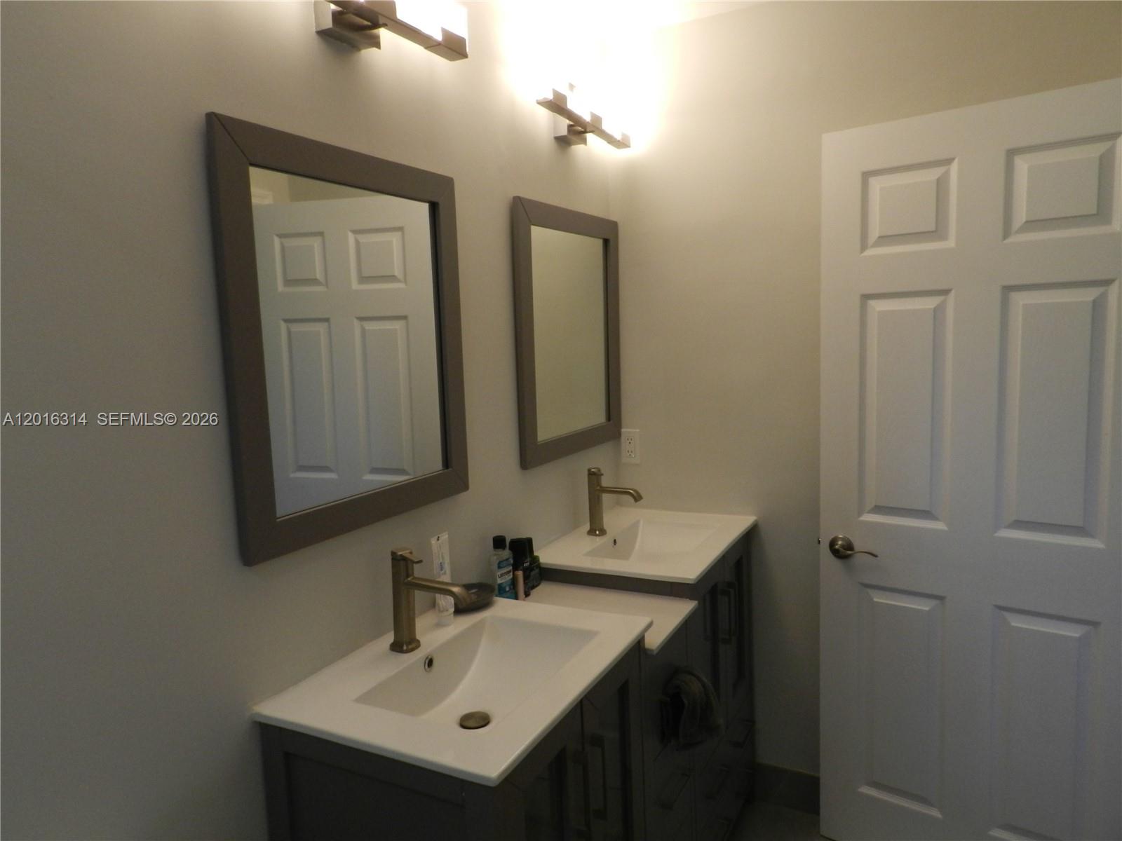 305 Northwest 42nd Street Boca Raton, FL 33431 - Photo 16 of 31 a bathroom with a sink and a mirror
