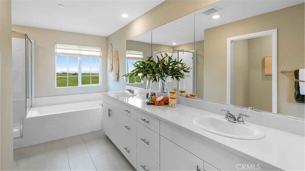 1678 Phantom Lane Rialto, CA 92376 - Photo 11 of 18 a bathroom with a tub sink and mirror