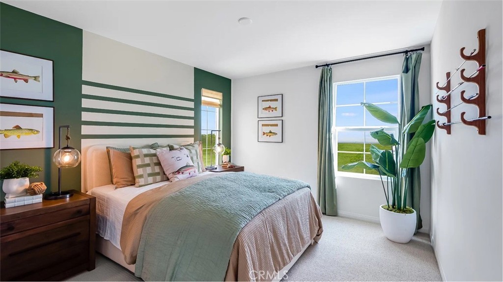 1678 Phantom Lane Rialto, CA 92376 - Photo 7 of 18 a bedroom with a large bed and a potted plant