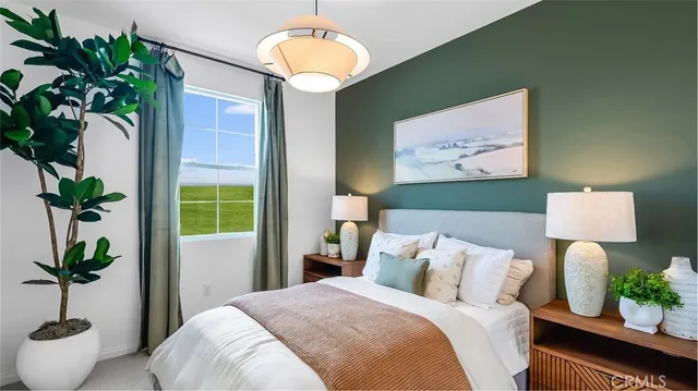 a bedroom with bed and a potted plant