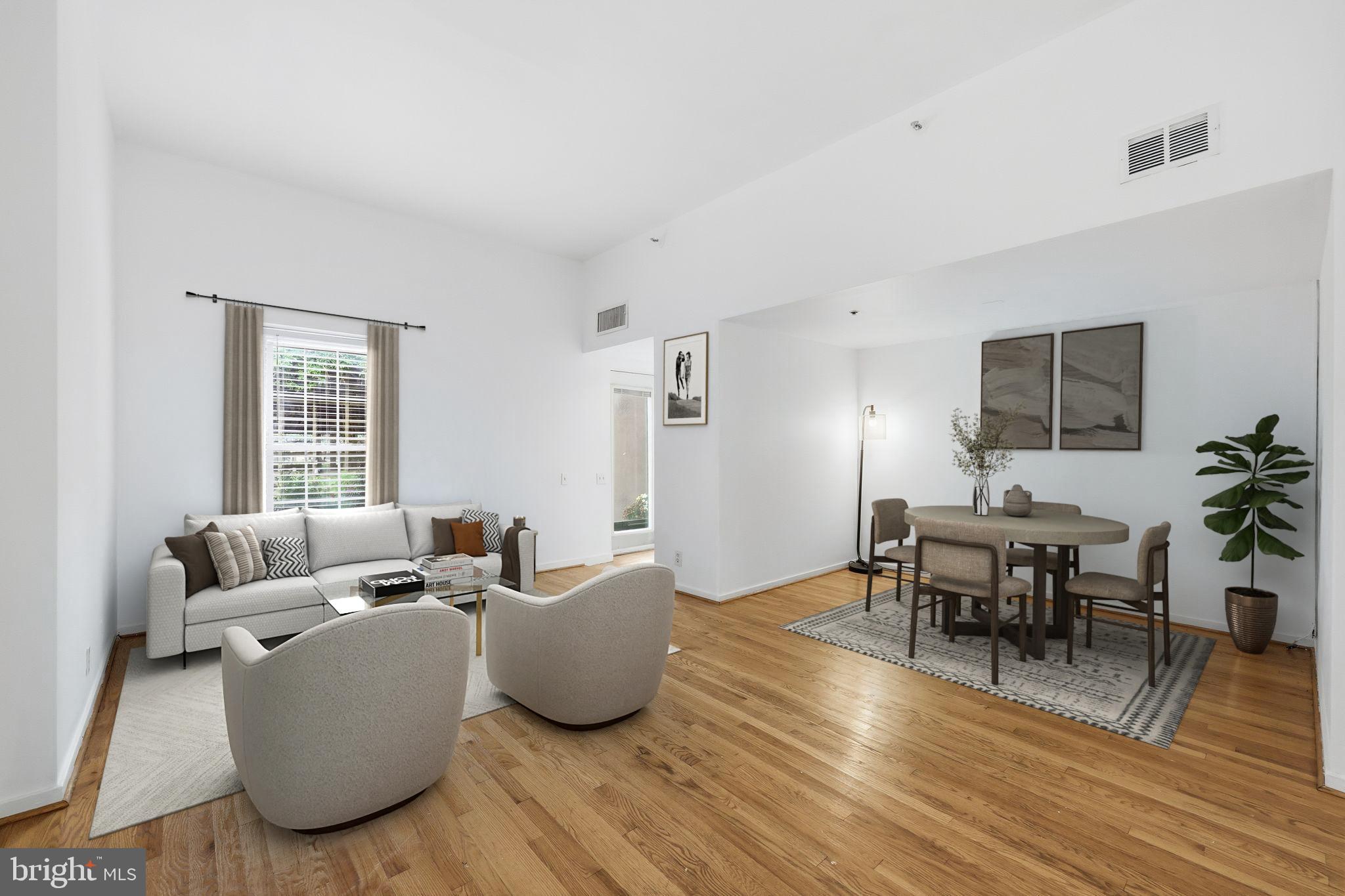 301 Race Street, Unit C010 Philadelphia, PA 19106 - Photo 1 of 32 a living room with furniture and wooden floor