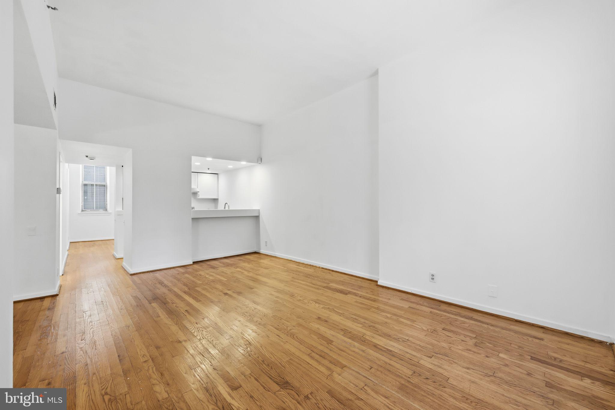 301 Race Street, Unit C010 Philadelphia, PA 19106 - Photo 11 of 32 a view of an empty room with wooden floor and a window