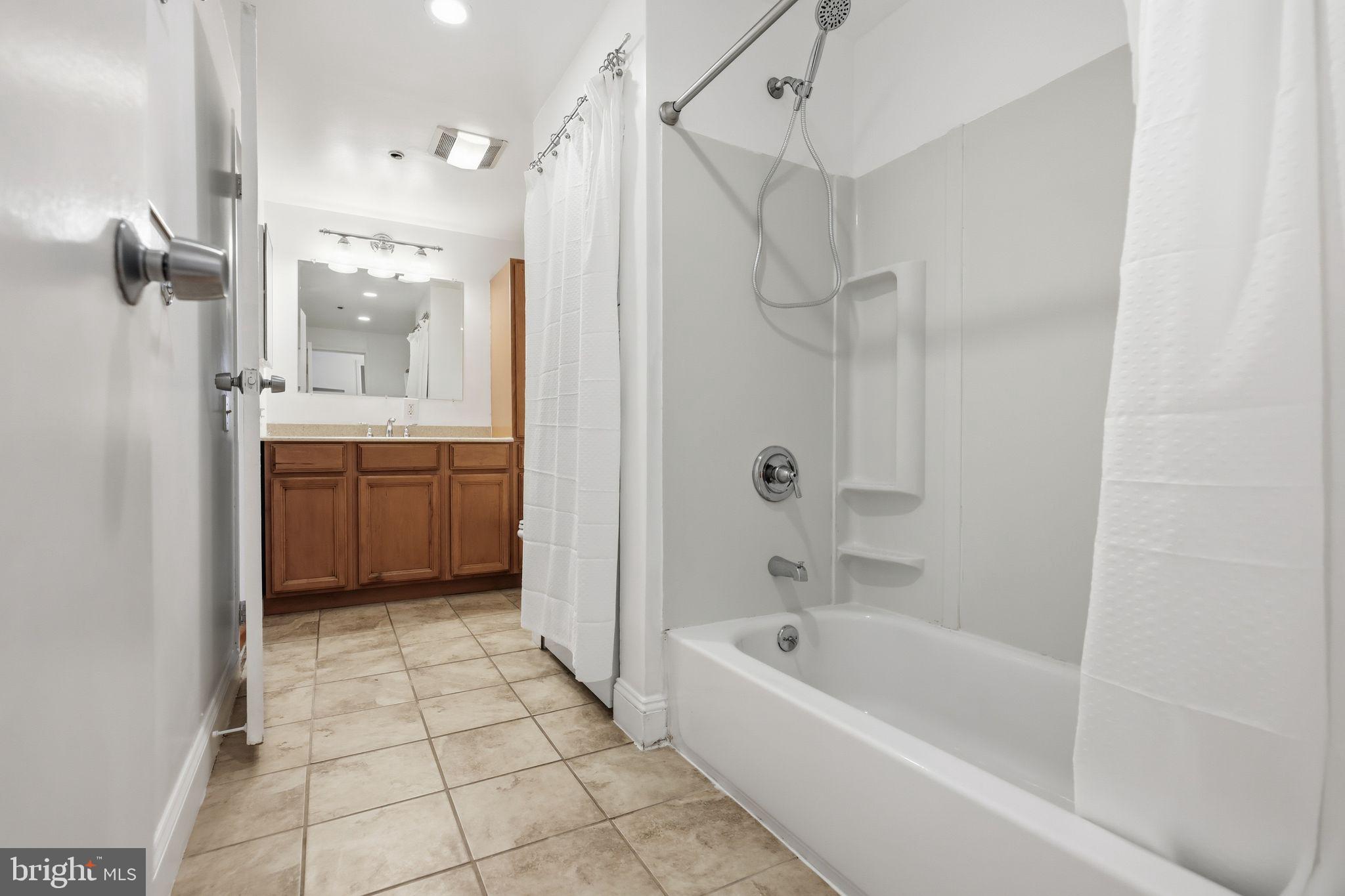 301 Race Street, Unit C010 Philadelphia, PA 19106 - Photo 15 of 32 a bathroom with a bathtub and a shower