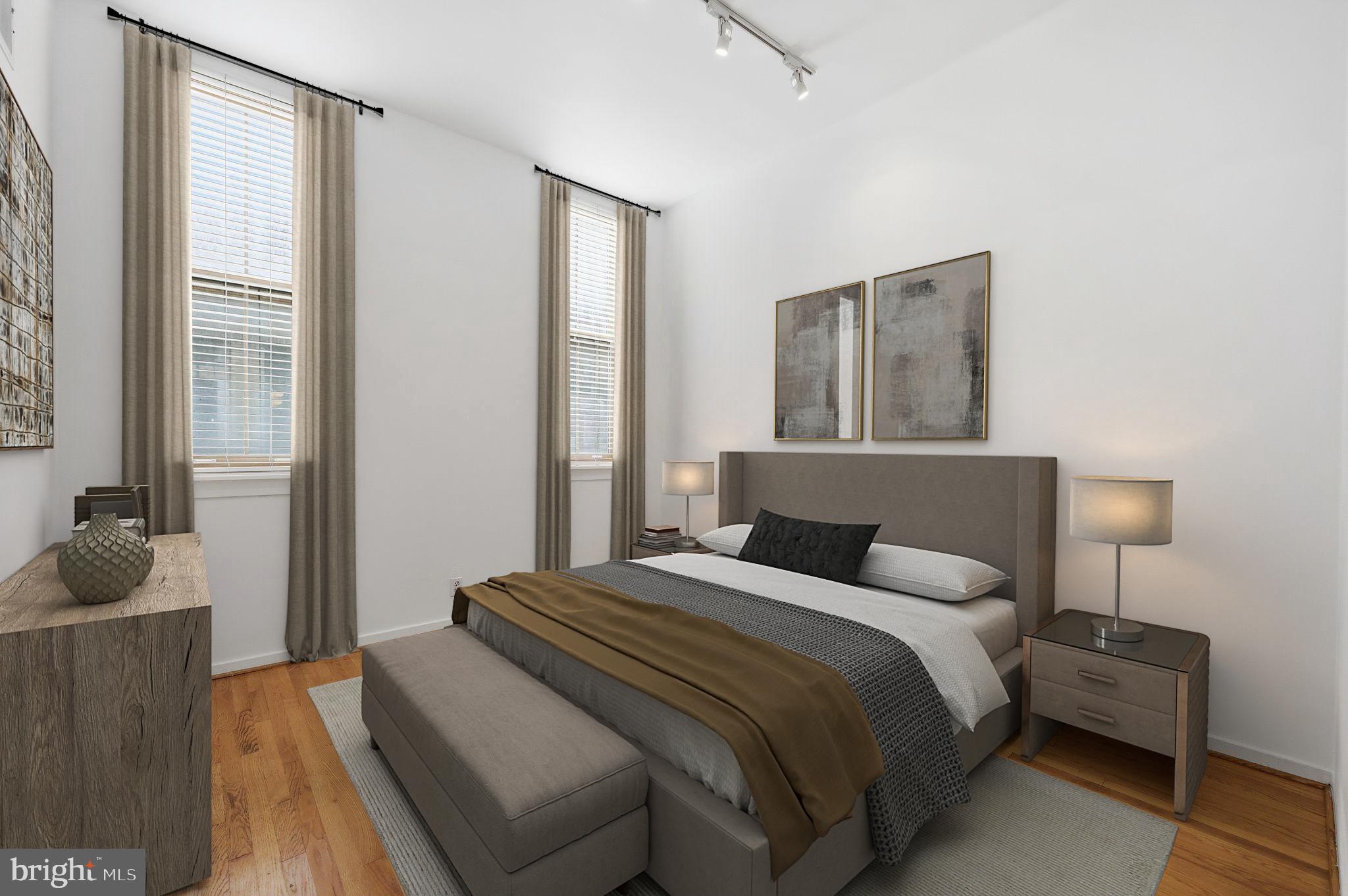301 Race Street, Unit C010 Philadelphia, PA 19106 - Photo 20 of 32 a bedroom with a bed and wooden floor