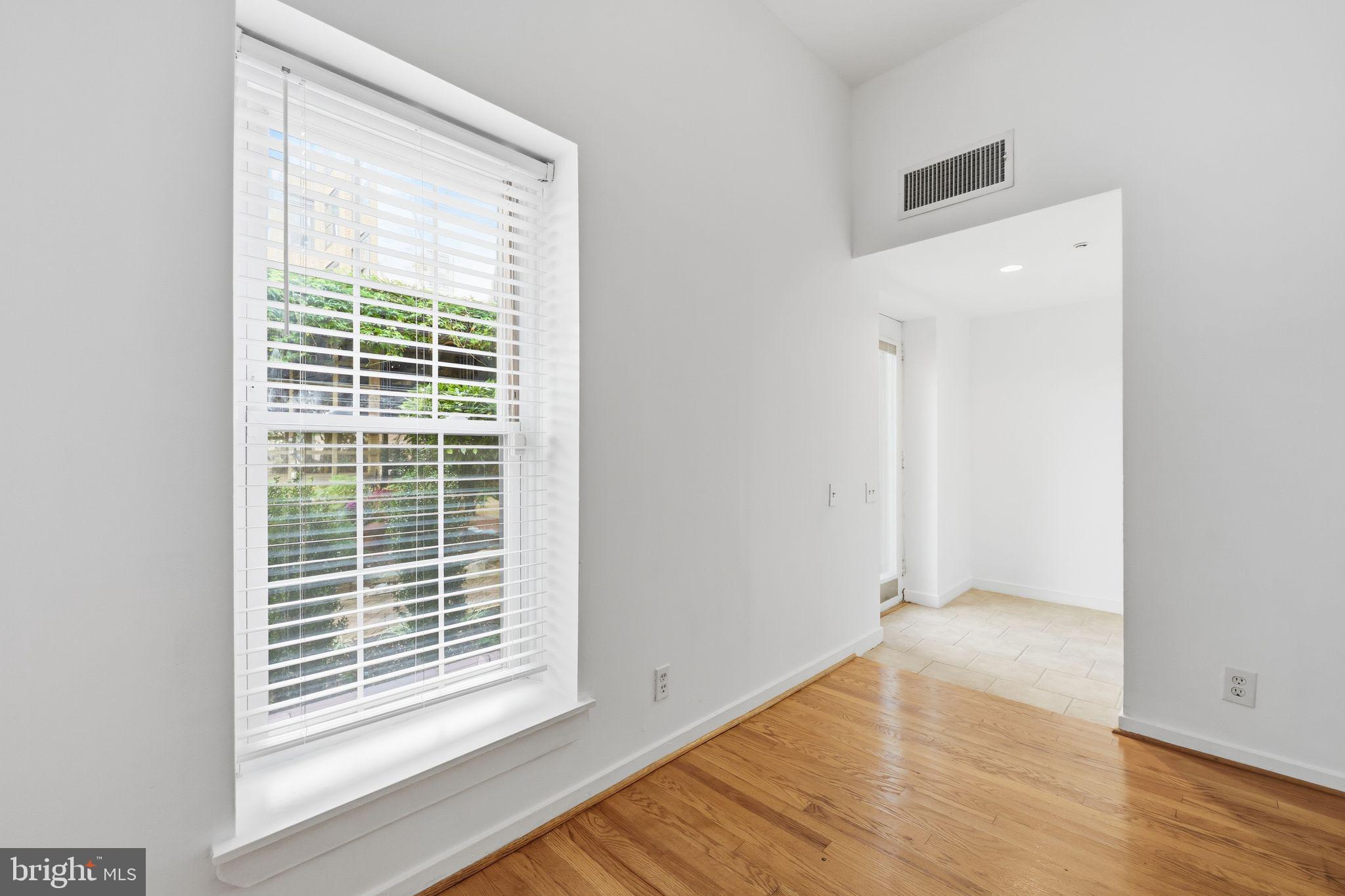 301 Race Street, Unit C010 Philadelphia, PA 19106 - Photo 7 of 32 a view of an empty room with wooden floor and a window