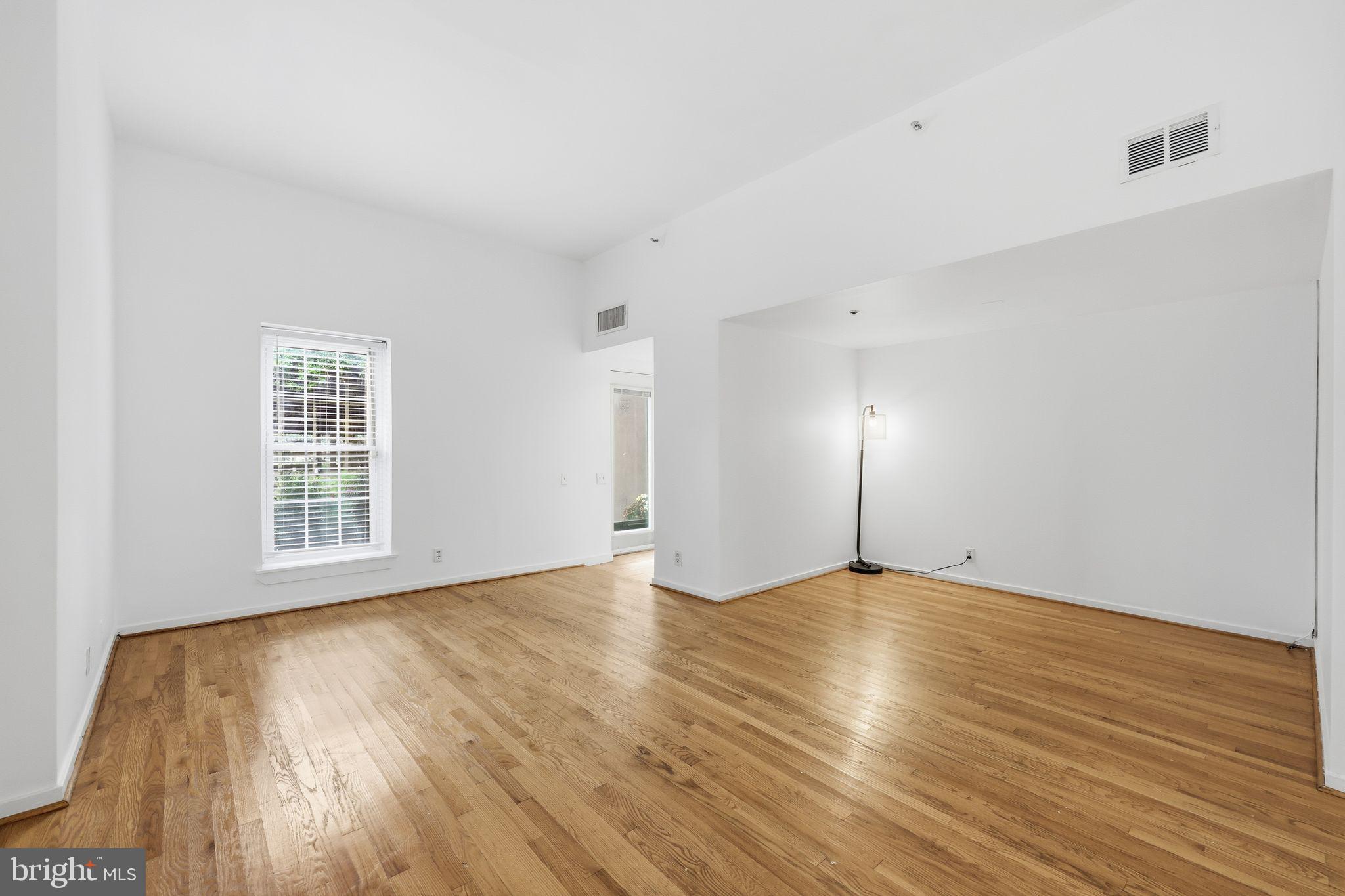 301 Race Street, Unit C010 Philadelphia, PA 19106 - Photo 8 of 32 a view of an empty room with wooden floor and a window