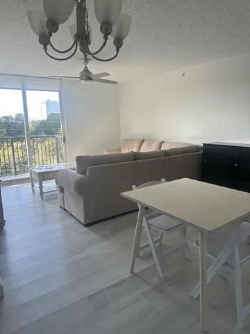 a living room with furniture and a floor to ceiling window