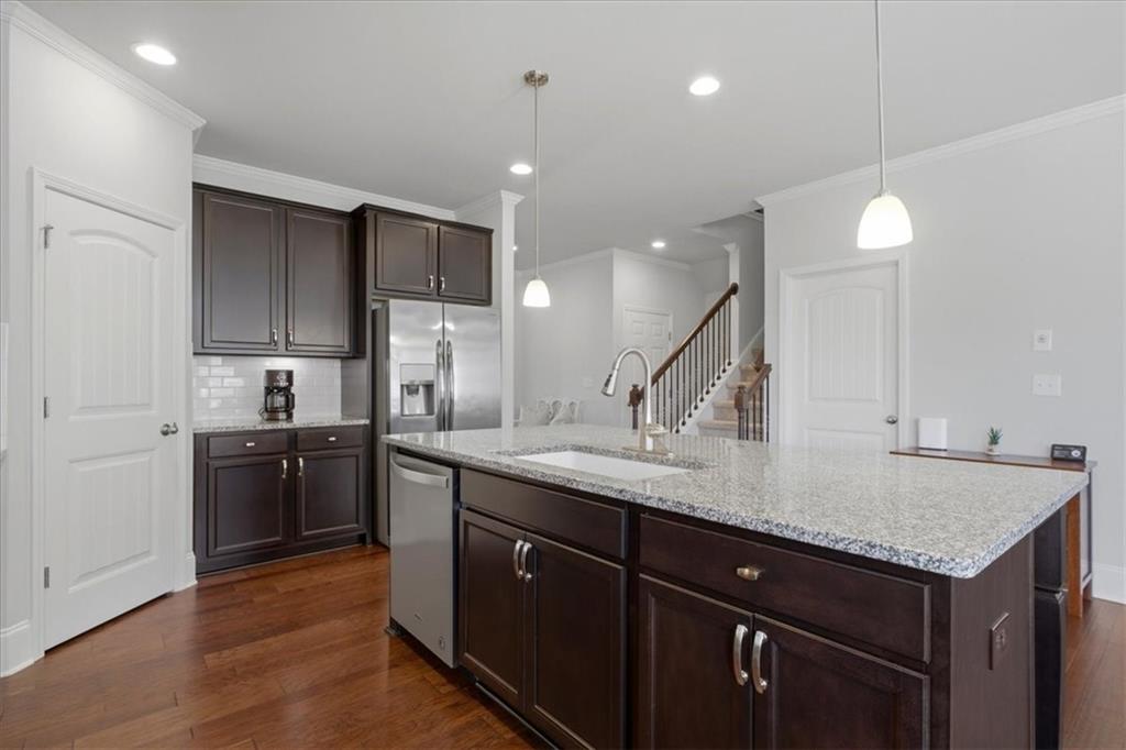 621 Little Bear Loop Canton, GA 30114 - Photo 12 of 45 a kitchen with stainless steel appliances granite countertop a sink a stove and oven