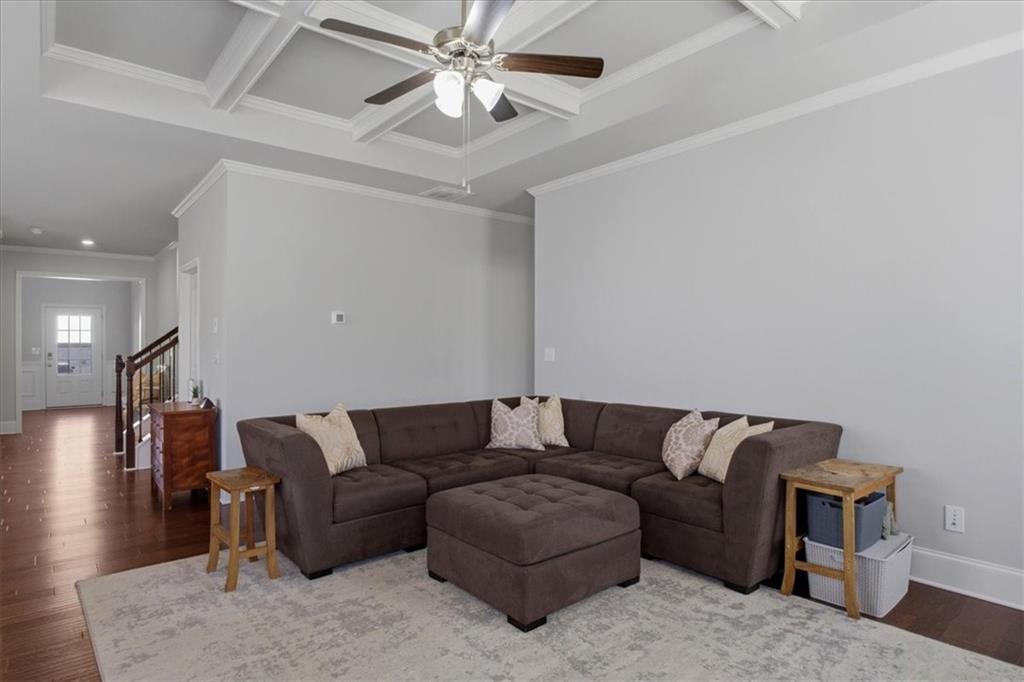 621 Little Bear Loop Canton, GA 30114 - Photo 18 of 45 a living room with furniture and a chandelier