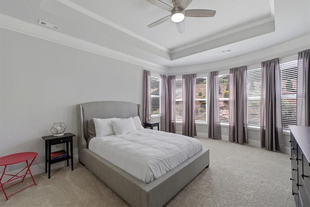 621 Little Bear Loop Canton, GA 30114 - Photo 19 of 45 a bedroom with a large bed and a chandelier