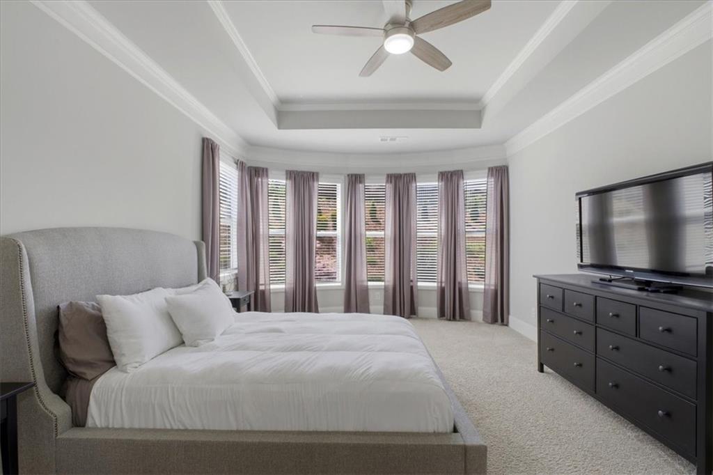 621 Little Bear Loop Canton, GA 30114 - Photo 20 of 45 a bedroom with a large bed and a flat screen tv