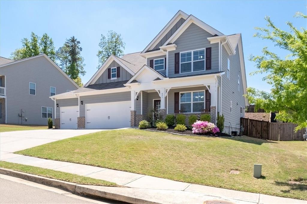 621 Little Bear Loop Canton, GA 30114 - Photo 2 of 45 a front view of a house with a yard and potted plants